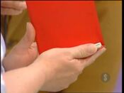 She picks the red autograph book.