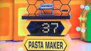 She bids $45 on the pasta maker. A difference of $8. She picks card #15.