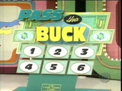 The current Pass the Buck game board using 6 numbers instead of 8. Note that the spaces were #'s 1 and 2 originally were are replaced with dollar bill graphics, as stated above.