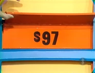 The luggage is $97 for a total of $341 thus far. If the flatware is $49 or more, she wins.