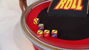 On her first roll, she has 4 cars and $1,000. She decides to roll again.
