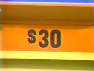 The jeans are $30 for a total of $72 in the keep column thus far. If the bakeware is more than $11, she wins.