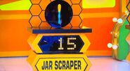 She bids $15 on the silicone jar scraper and is exactly right! And, she automatically wins the $42 Easttop harmonica & case. She picks cards #27 and #21.
