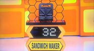She bids $35 on the electric sandwich maker. A difference of $3. She picks card #25.