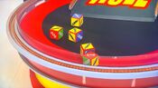 On her first roll, she has 3 cars and $2,000. She decides to roll again.