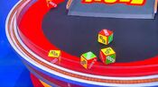 On his second roll, he has 2 dollar signs and $7,500. He decides to roll again.
