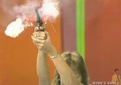 The contestant fires the starting pistol.