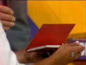 She picks the red autograph book.