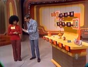 The first playing of Hi Lo. Check out the contestant's hair! Now, instead of the familiar rules, here's how it works: With each pick, the player must tell Bob which row each product's price goes.