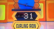 She bids $25 on the curling iron. A difference of $6. She picks card #5.