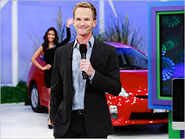 Neil Patrick Harris flashes a smile to the audience while presenting his showcase. Notice Manuela waving in the background