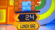 She bids $16 on the Packit freezable lunch bag. A difference of $8. She picks card #19.