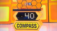 She bids $10 on the compass. A difference of $30. She gets no card.