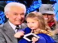 Bob holding a little girl, waving goodbye to the camera at the end of a "Price is Right" episode