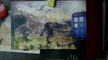 A postcard of a Raptor, Ankylosaurus, Triceratops and the TARDIS on the Planet Siluria.