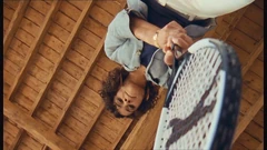 Caroline waiting to attack Rex with a tennis racket