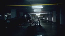 A Kaprosuchus investigating a smashed car containing Connor