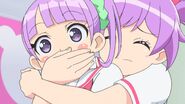 Laala covering Non's mouth