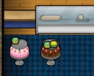 Cakes and cupcakes displayed on Cake Stands, bread displayed in a Display Counter