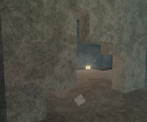 A camp dug out in a wall, seemingly lived in, containing a lit lantern and two beds