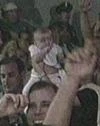 A baby in the crowd.