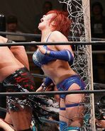 Kana gets thrown into a barbed wire board.