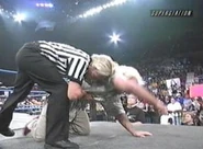 Charles Robinson assists Ric Flair in getting out of the ring.