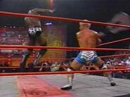 Jeff Jarrett attacking Booker T with his guitar.