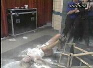 Miss Hancock laying after the floor after being laid out by Daffney and powder being thrown on her.