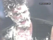Vince Russo's face is covered with cake.