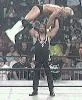 Brian Adams lifts Lex Luger over his head to give him a gutbuster.