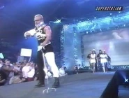 Jeff Jarrett walks to the ring with a neck brace, arm in a sling, one leg in a cast, and a crutch.