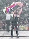 Bryan Adams does a triple press slam on Davey Boy Smith.