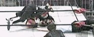 La Parka hits a move on Ultimo Dragon from the top rope.