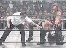 Kevin Nash applies a backbreaker.