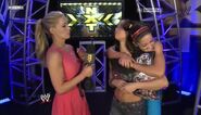 Renee Young interviews the Divas Champion AJ Lee while Bayley congratulates her in the backstage.