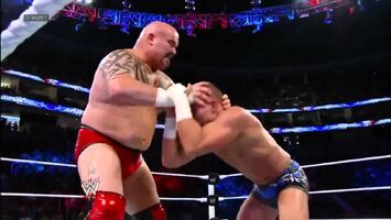 Tensai performing a claw hold on tyson kidd