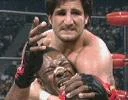 Disco Inferno applies a headlock on Booker T.