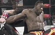 Booker T in a tough submission move.