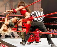 Maryse ducks between the ropes out of Brie's grasp.