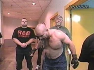 Tank Abbott walks out of his locker room with security.