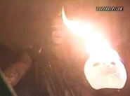 Vampiro burns a Sting mask while cutting a promo.