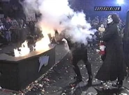 Sting sprays Vampiro and the announce booth with a fire extinguisher to put out the fire.