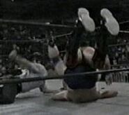 Scott Hall pinning Roddy Piper with his feet on the ropes.