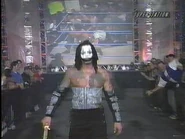 Vampiro walking towards the ring with a kendo stick.