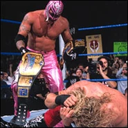 Mysterio and Edge celebrating with their newly won WWE Tag Team Championship.