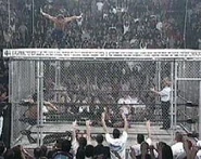 Thunder 2-18-99 9.jpg (16 KB) Chris Benoit jumping off the top of the cage onto Brian Adams.
