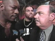 Gene Okerlund interviewing Booker T as the Misfits watch.