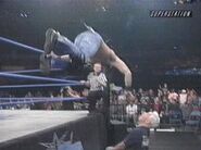 Crowbar jumping outside of the ring onto David Flair.