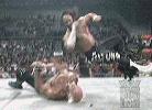 Randy Savage hits an elbow from the top rope.